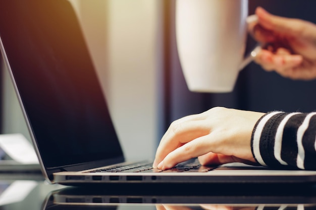 Close-up of person using laptop
