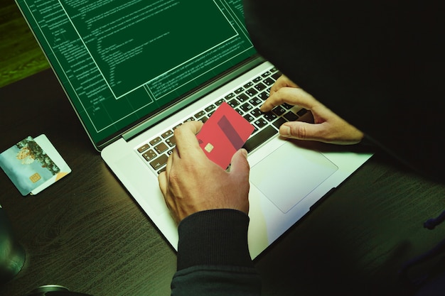 Close up of programmer of hacker hands typing a code
