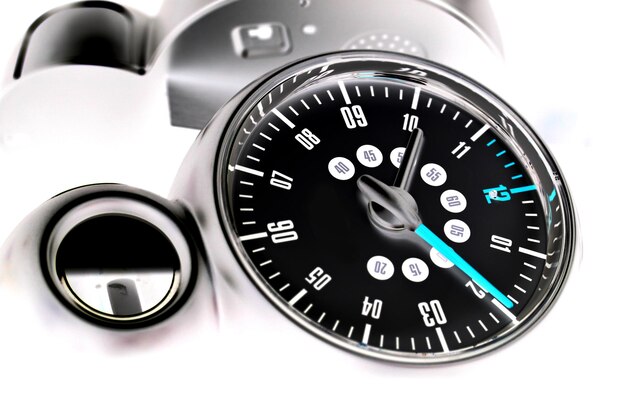Close-up of speedometer on white background