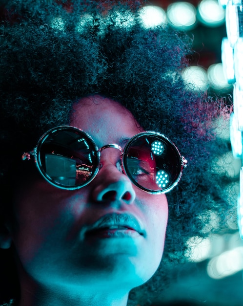 close-up of woman against illuminated lighting