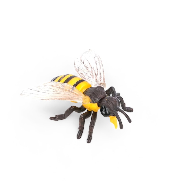 closeup of a miniature toy bee animal on a white background