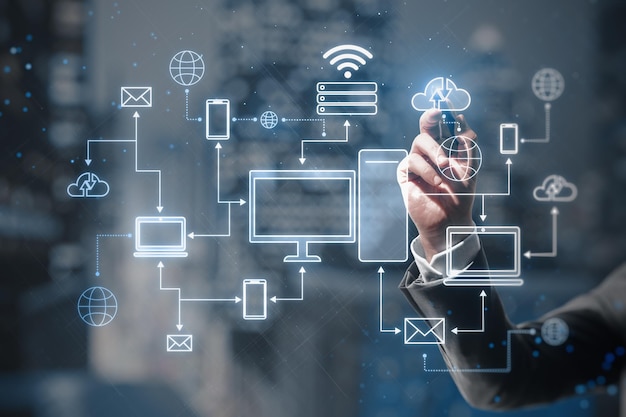 cloud computing technologies concept with man hand using stilus on virtual touch screen with digital electronic devices connected between each other on blurred abstract background