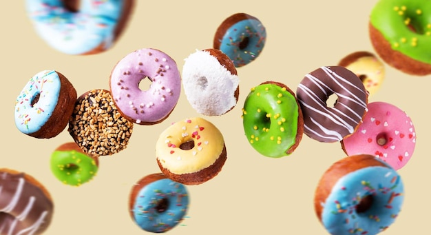 colorful donuts flying on yellow background sweet food background