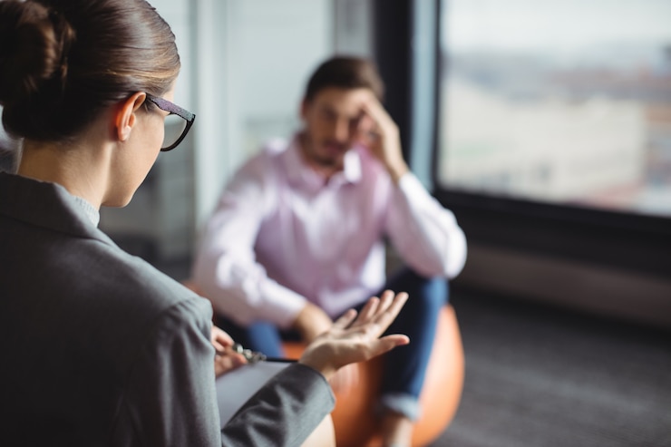 Fotografie counselor interacting with unhappy man