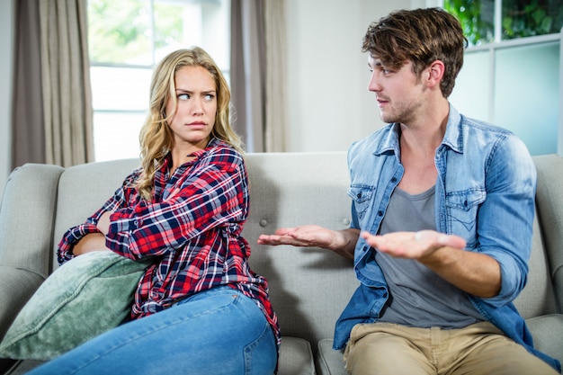 couple having an argument on the sofa