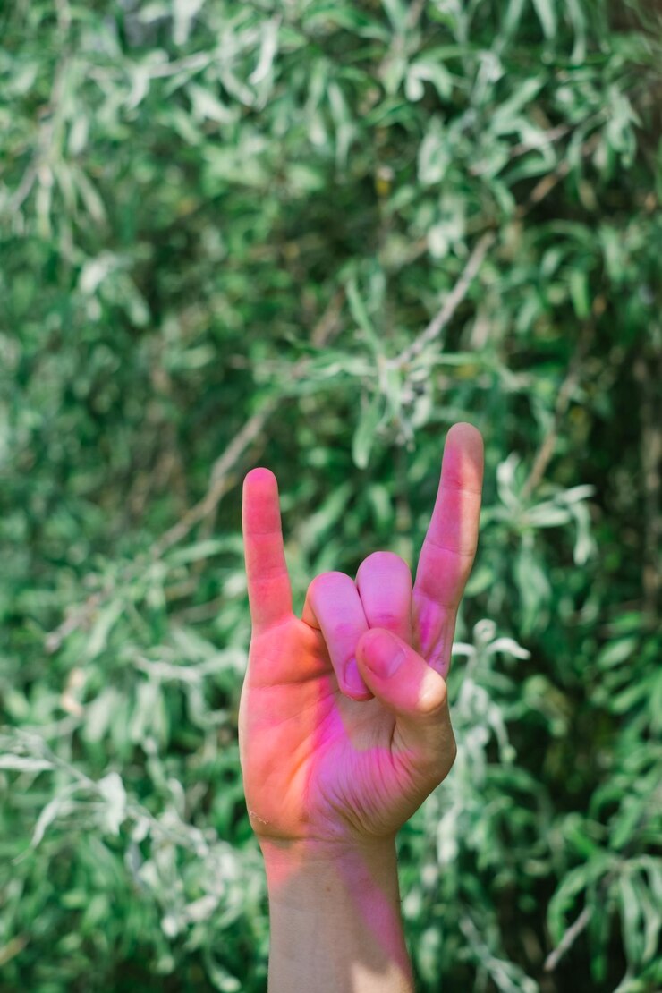 Fotografie cropped hand gesturing horn sign against tree