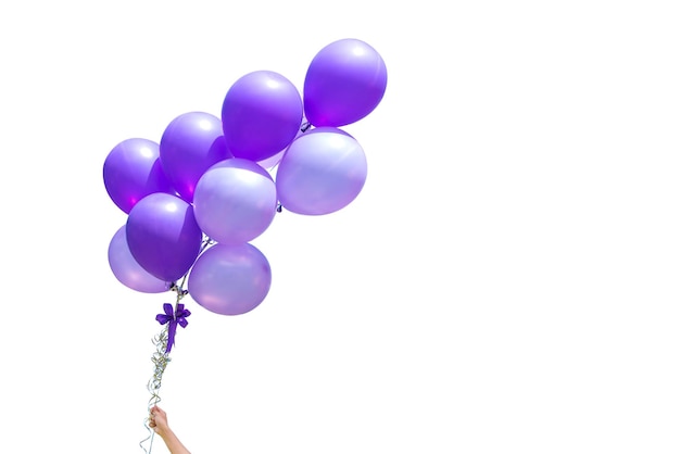 Cropped hand holding purple balloons against white background