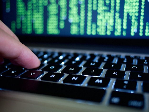 cropped hand typing on laptop keyboard
