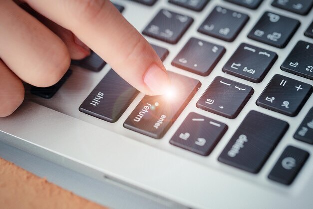 Cropped hand using laptop
