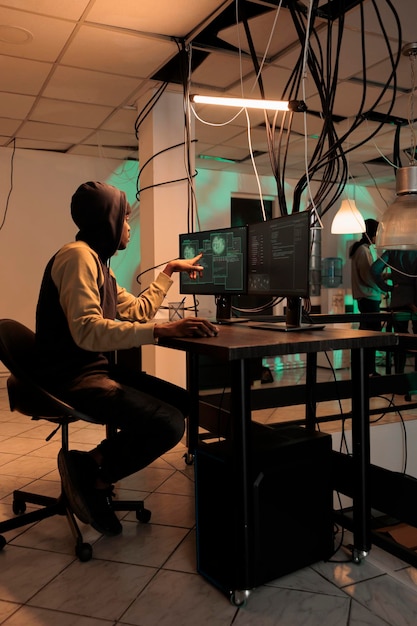 Cyber security, encryption specialist fixing database cyberattack, developer coding antivirus program. African american coder programming app, cybersecurity technology, computer system protection