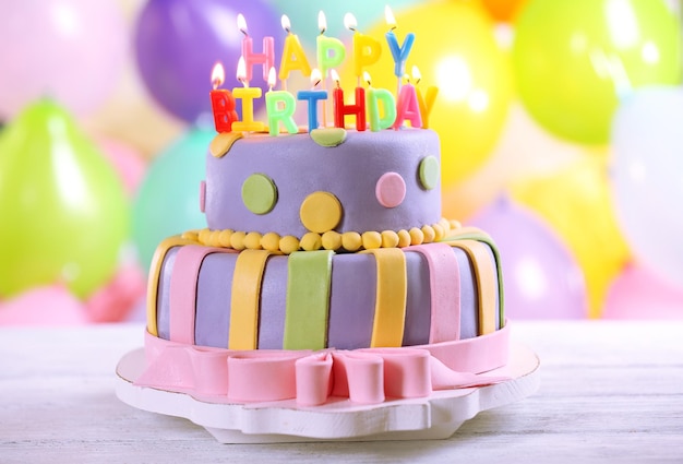 delicious birthday cake on bright background