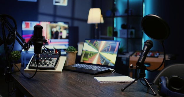 Desk in empty studio with podcast gear technology