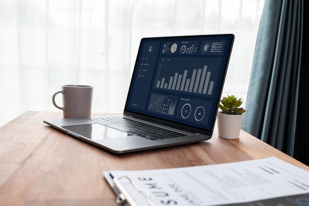 Desk in office with laptop display Fintech dashboard data Enthusiastic