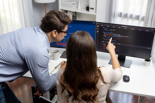 Developers program coding discussing website planning software Postulate