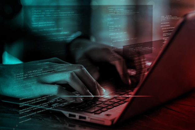 Digital technology software development concept Coding programmer software engineer working on laptop with circuit board and javascript on virtual screen internet of things IoT
