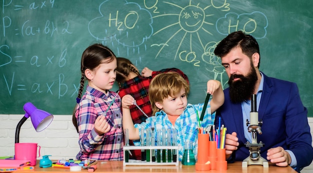 discover and explore properties of substances together interests and topic club older kids help younger school club education teacher and pupils test tubes in classroom chemistry themed club