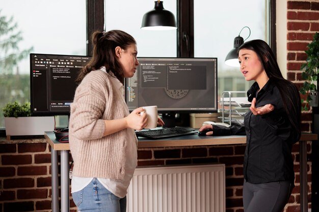 Diverse tech enginners developing software algorithm for information processing and network optimization. Software developers programming application working in it company office