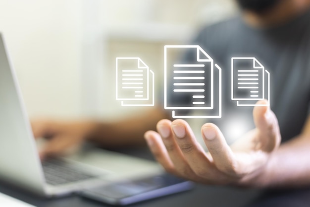 electronic document concept businessman use laptop with virtual document on hand online file storage digital on cloud computing