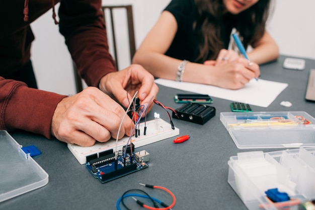 Engineers assembling electronic construction