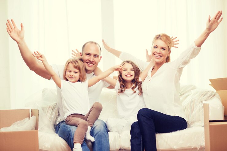 Fotografie family, children, accomodation and home concept - smiling parents and two little girls waving hands at new home