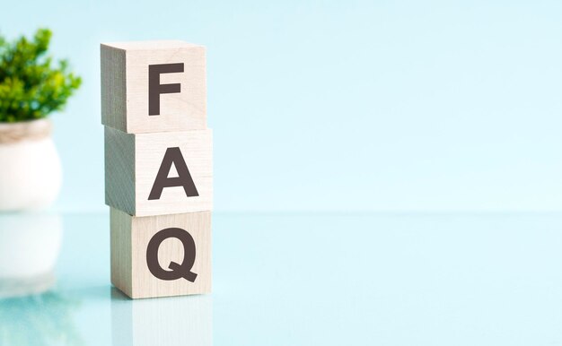 FAQ text on wooden blocks on wooden background business concept