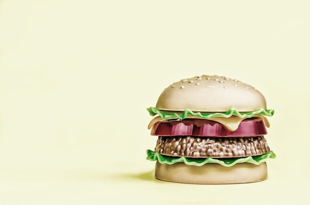 Fast food. plastic french fries on a yellow background. copy space. horisontal
