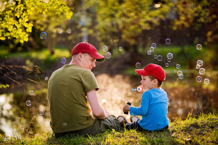 Fotografie father and son on the shore of the lake