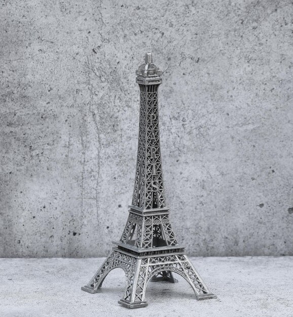 figurine of the eiffel tower on a gray background