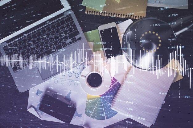Financial market graph and top view computer on the desktop background Multi exposure Investment concept
