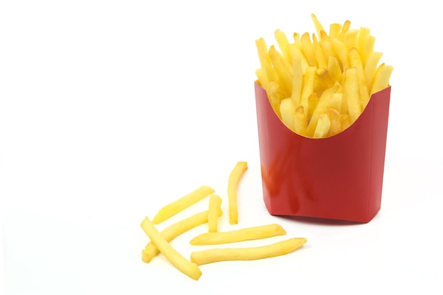 french fries in a red carton box in closeup and isolated on white background with copy space place