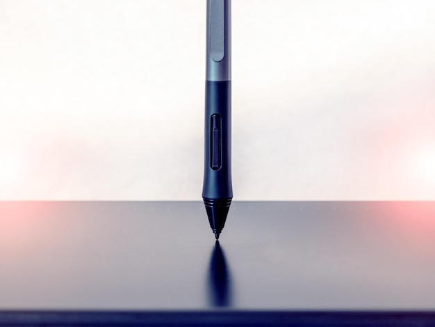 graphic tablet and pen stylus with stand on a light background