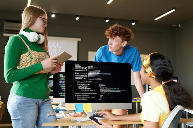 Group of students working over software on computer in team in the classroom