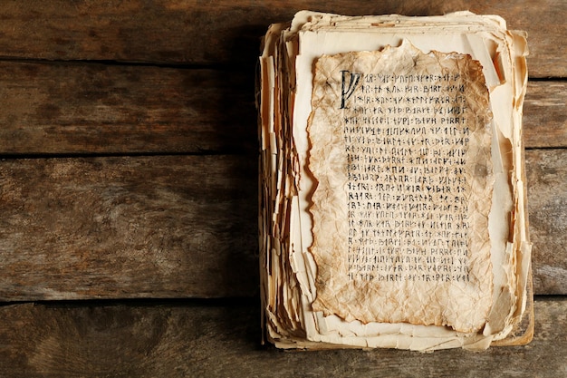 Grunge papers with hieroglyphics on wooden background