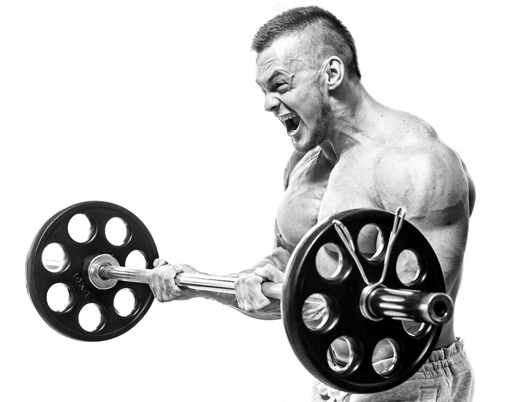 Fotografie gym handsome man during workout lifting heavy halter