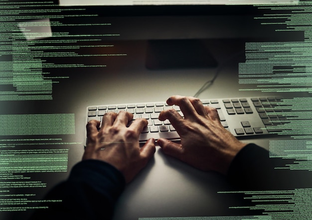 Hacker coding and hands in night with keyboard hologram and information technology criminal and person Dark illegal and programming of database overlay and risk of cyber security in office