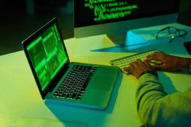 hands person or hacker stealing on computer for cybercrime scam malware or phishing for online data programmer password theft or pc software update on tech for hacking server on website in night