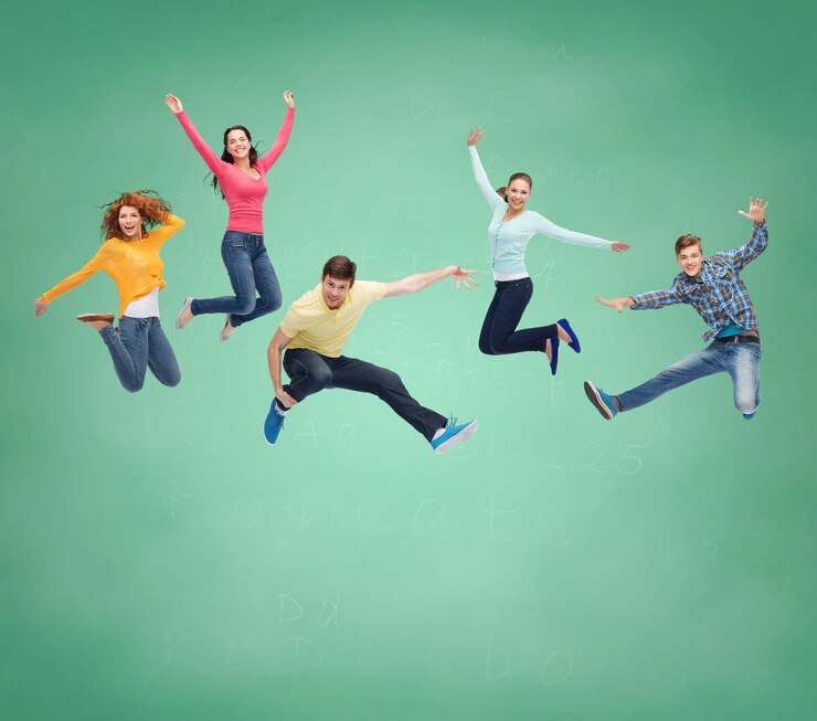 Fotografie happiness, freedom, friendship, education and people concept - group of smiling teenagers jumping in air over green board background
