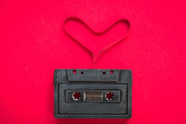 heart shape from cassette tape over paper background