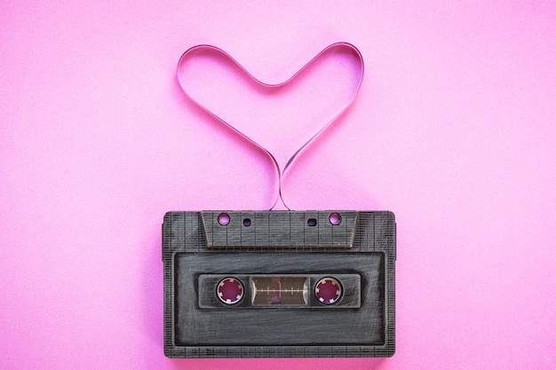 heart shape from cassette tape over paper background