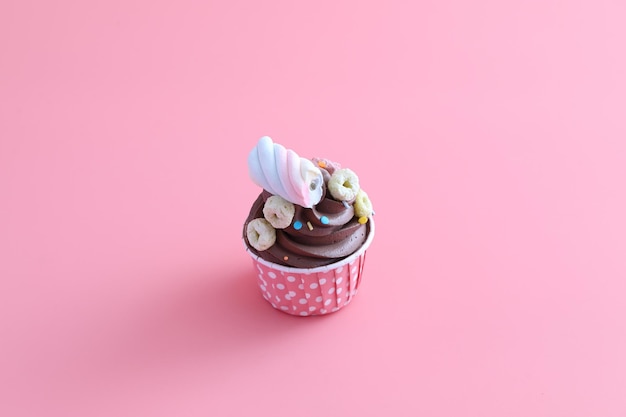 High angle view of cupcakes against pink background