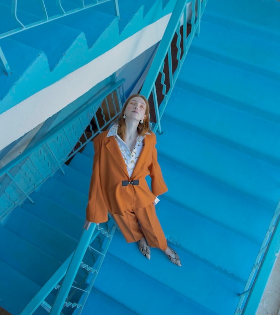 high angle view of teenage girl with eyes closed standing on steps