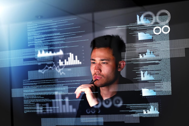 Holographic programmer and Asian man with focus night and futuristic with cyber security analytics or software update Male person professional or employee with data analysis future and hologram