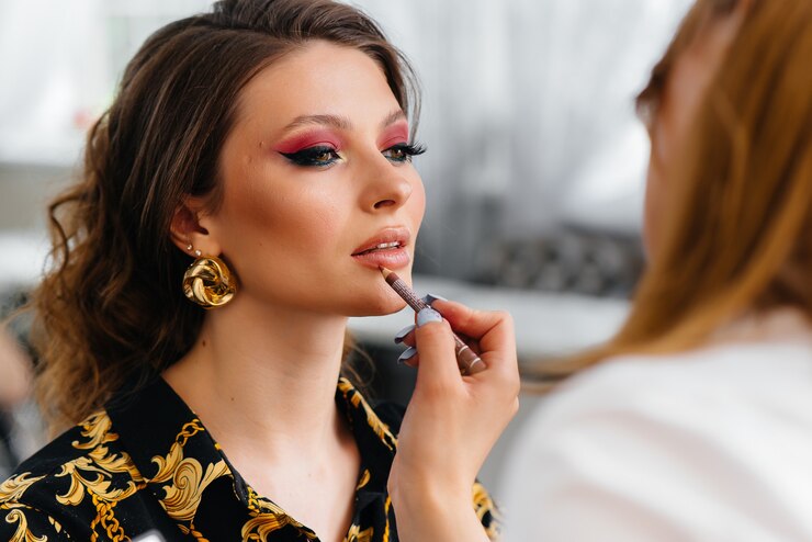 Fotografie in a beautiful, modern beauty salon, a professional makeup stylist makes makeup for a young girl. beauty, and fashion.