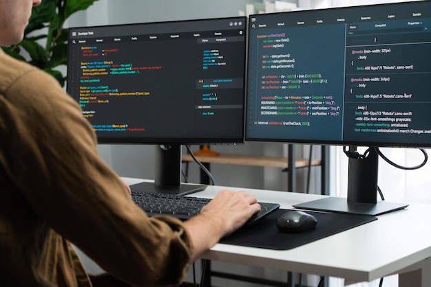 it developer working online software development coding on pc screens gusher