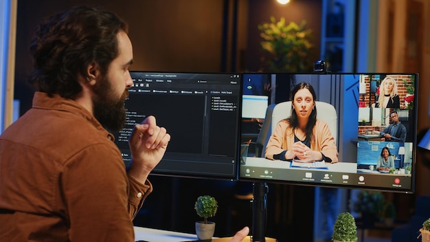 IT professional at home in remote teleconference meeting with coworkers