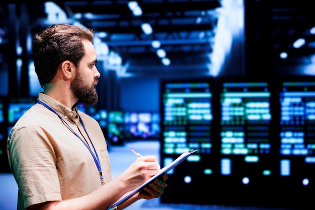 IT programmer monitoring server hub security to protect information access, making sure virus protection software is updated and hackers trying to penetrate data center systems are rejected