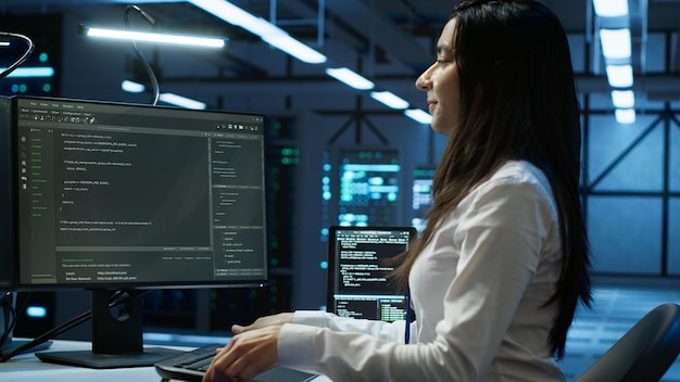 IT specialist in server hub starting job shift tracking network traffic with PC