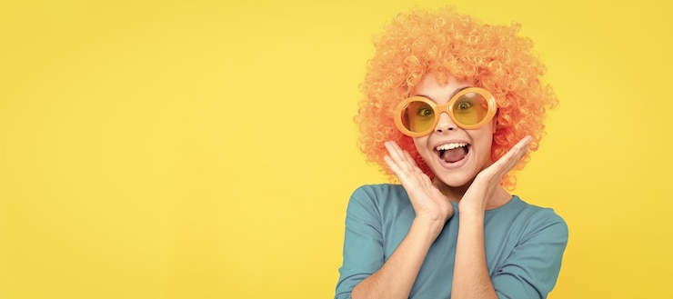 Fotografie look at that april fools day happy childhood girls birthday party happy funny kid funny teenager child in wig party poster banner header copy space