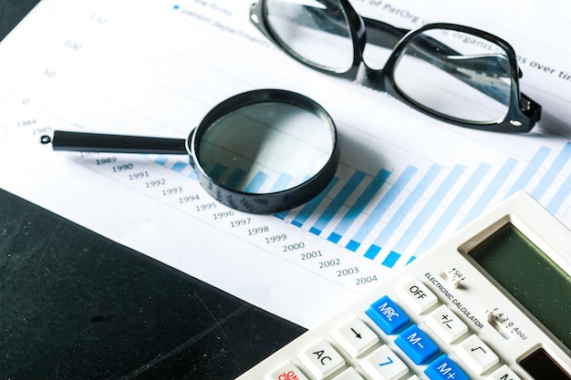 Magnifying glass and business growth graph
