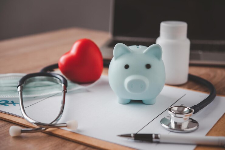 Fotografie medical insurance concept with piggy bank and stethoscope on wooden desk